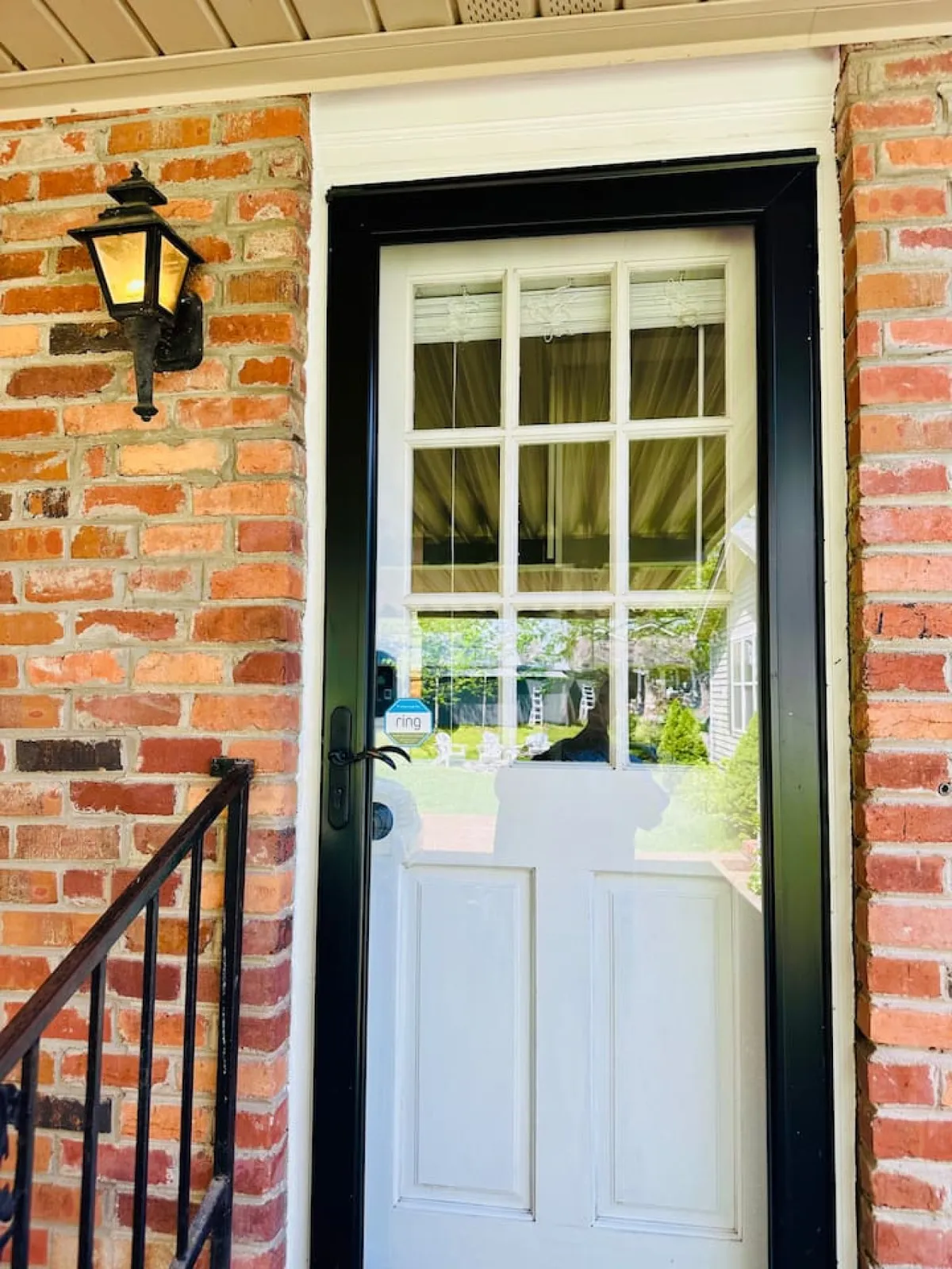 A welcoming brick exterior featuring a private front door and an inviting outdoor light fixture. The entryway is clear and personal, providing a sense of privacy and a dedicated entrance for guests.